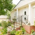 The front of a park home with stairs leading up to the front door and porch area